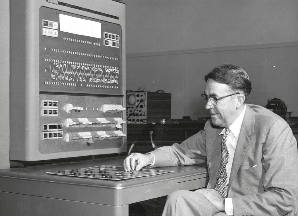 Artificial intelligence pioneer Arthur Samuel plays checkers with an IBM 704 computer in Poughkeepsie, New York.